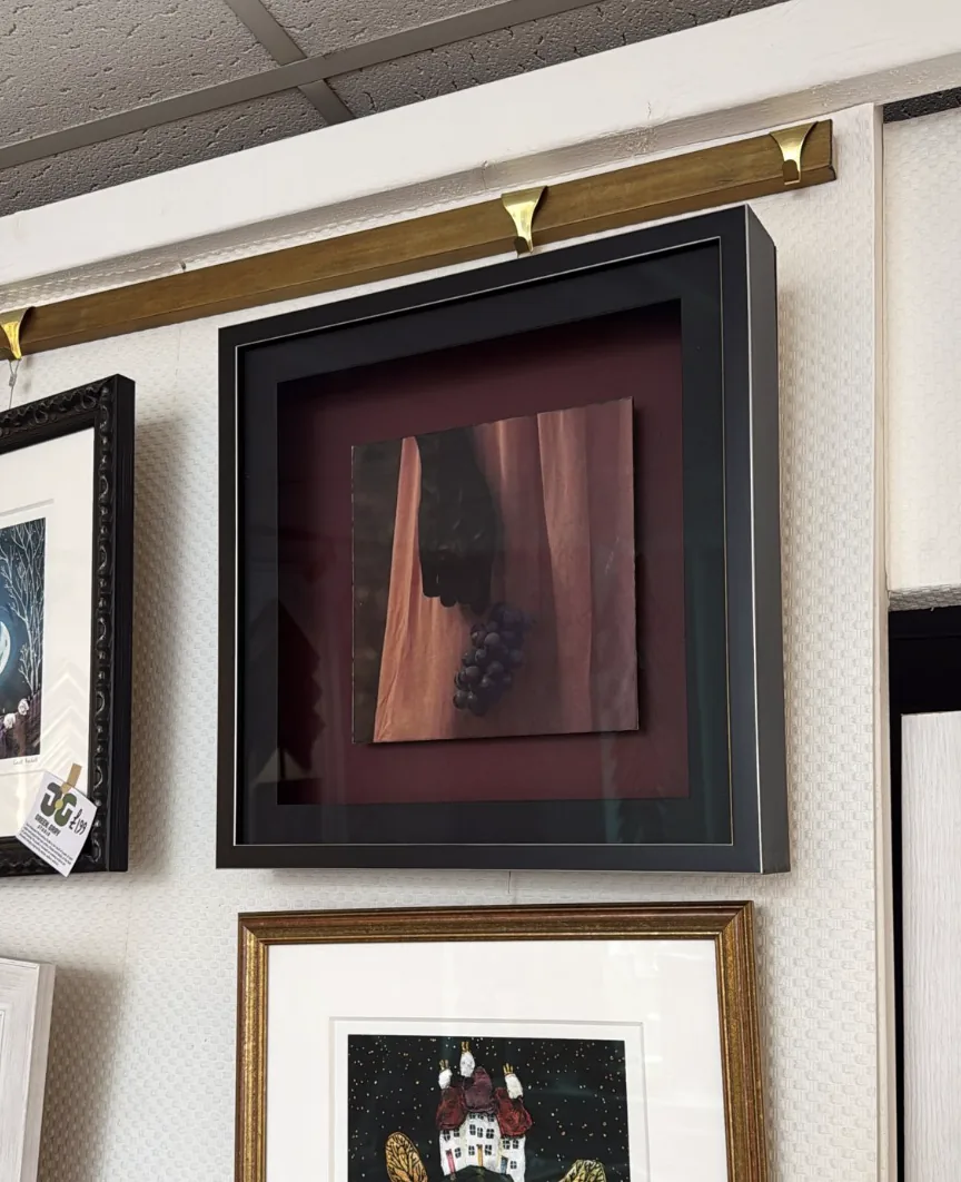 Real shadow box framed artwork with deep black frame and burgundy mount