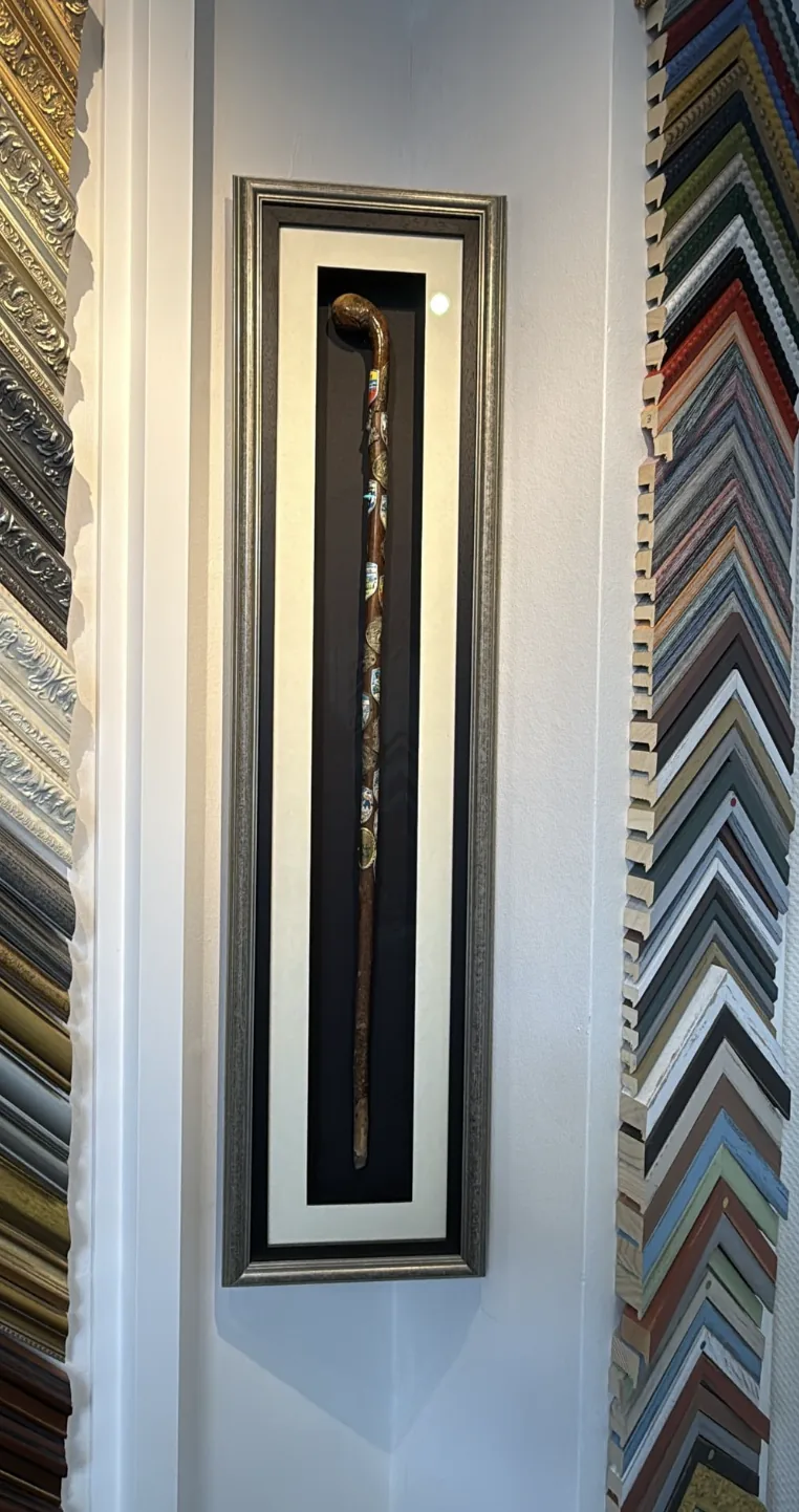 Real tall box frame with mounted carved walking stick