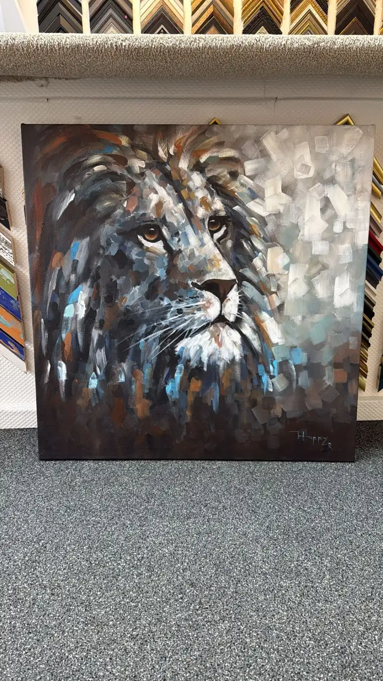 Real stretched lion canvas displayed in the framing shop