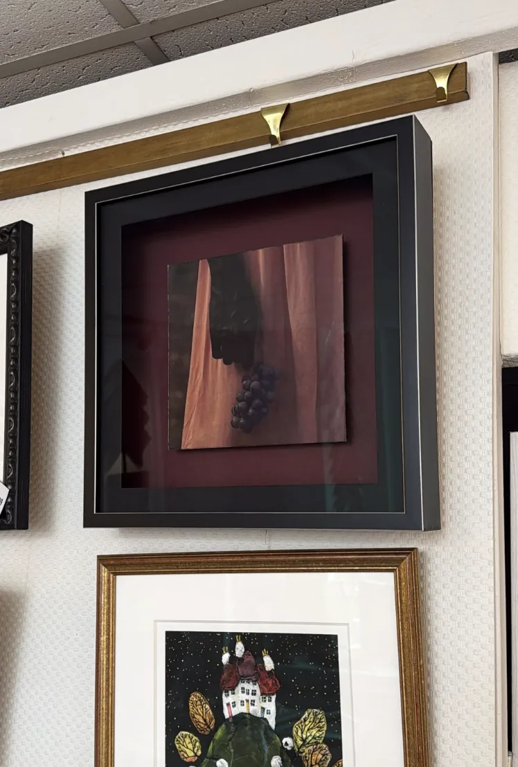 Real black shadow frame displaying mounted artwork in the shop