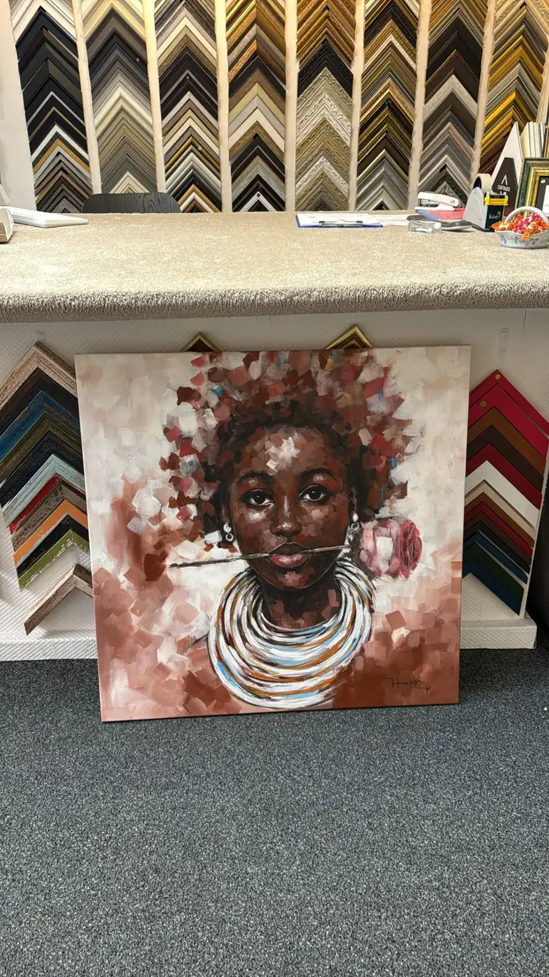 Real stretched floral portrait canvas in front of frame samples